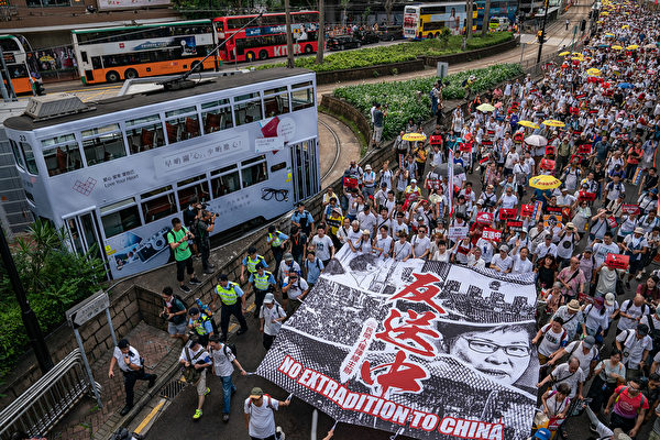 HONG KONG, HONG KONG - JUNE 09: Protesters march on a street during a rally against the extradition law proposal on June 9, 2019 in Hong Kong China. Hundreds of thousands of protesters marched in Hong Kong in Sunday against a controversial extradition bill that would allow suspected criminals to be sent to mainland China for trial.(Photo by Anthony Kwan/Getty Images)