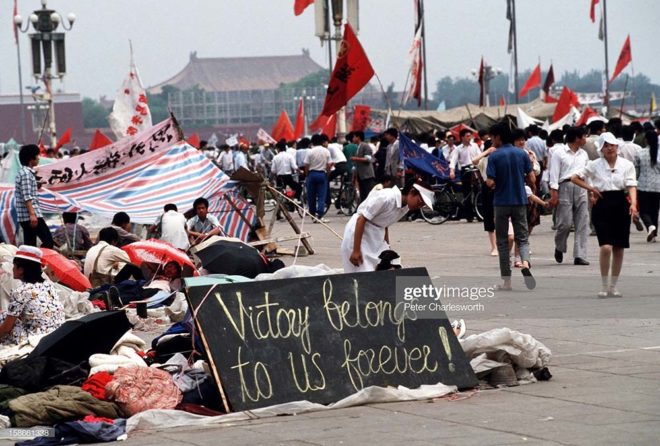 BEIJING, CHINA - 1989/06/01: A sign erected by pro-democracy demonstrators proclaims that "Victory belongs to us forever!" in Tiananmen Square. Pro-democracy demonstrators filled the square for weeks prior to the final nighttime Communist Government's bloody crackdown. Many camped out and slept in the square to keep the democracy protest movement going.. (Photo by Peter Charlesworth/LightRocket via Getty Images)